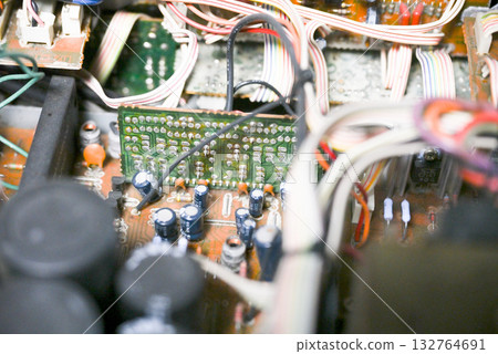 Close-up of the internal circuit board and electronic components of an audio amplifier 132764691