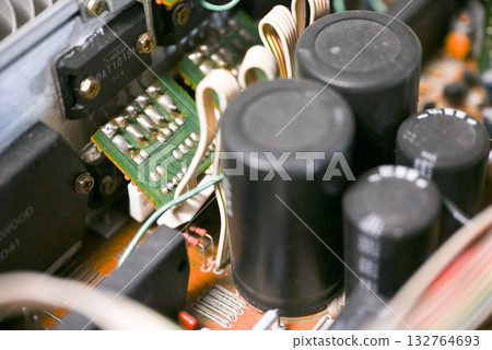 Close-up of the internal circuit board and electronic components of an audio amplifier 132764693