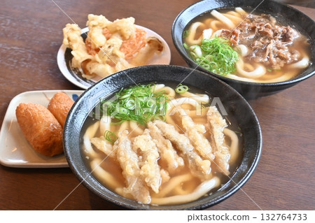 Set of meat udon and burdock tempura udon with inari and tempura 132764733