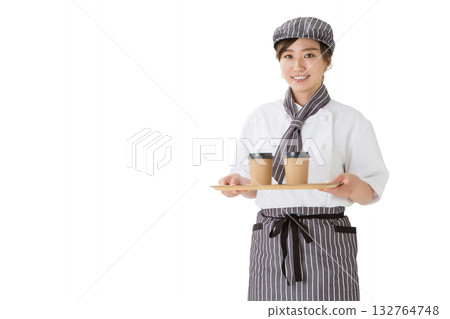 Waitress carrying coffee on a tray, woman wearing a chef's coat 132764748