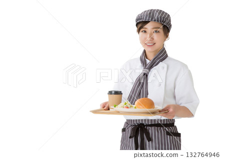 A woman in a chef's coat holding a hamburger on a tray A woman in a chef's coat holding a hamburger on a tray 132764946