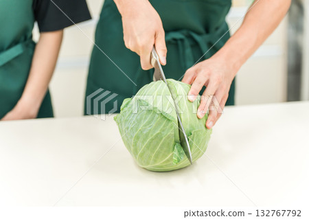 Kitchen, chef cutting cabbage in the back room Kitchen, chef cutting cabbage in the back room 132767792