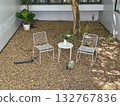 white metal chairs in the garden with rock ground 132767836