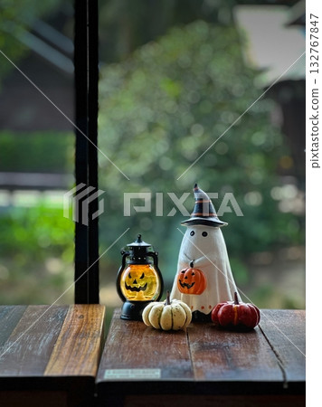 Halloween figure with small pumpkins on wood table Halloween figure with small pumpkins on wood table 132767847
