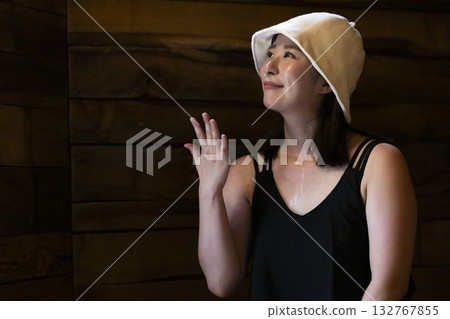 Woman enjoying the sauna Woman enjoying the sauna 132767855