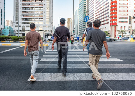 Crowded street with pedestrians, busy people crossing at green traffic light 132768080