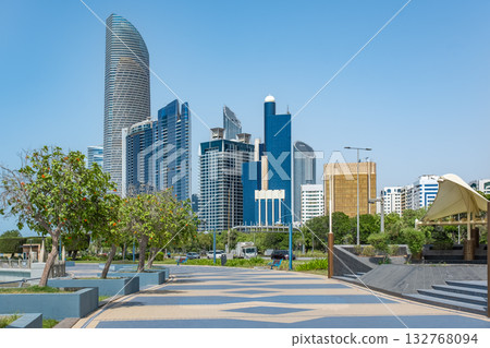 Corniche boulevard beach park along the coastline. Modern buildings of downtown Abu Dhabi 132768094