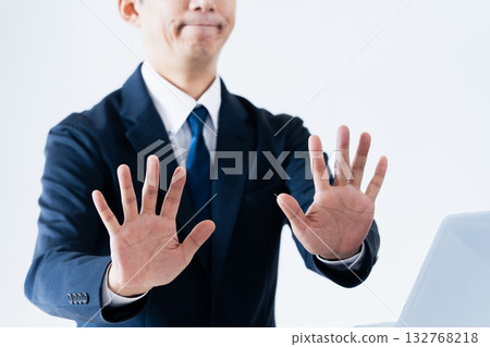 A man who makes a stop gesture 132768218