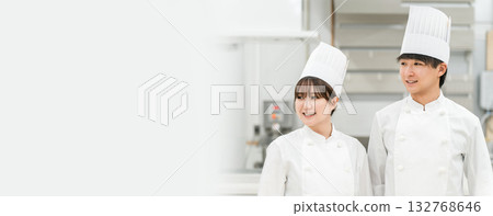 Chefs and cooks in chef coats standing in the kitchen 132768646