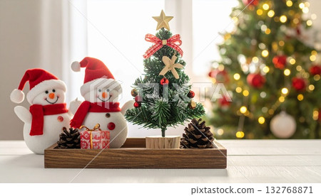 A room with a Christmas tree, a display of miniature trees, gifts, and snowmen A room with a Christmas tree, a display of miniature trees, gifts, and snowmen 132768871