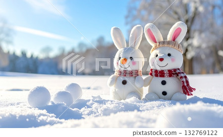 Stuffed rabbit making a snowman 132769122