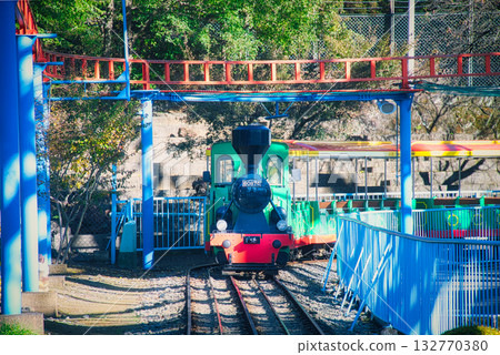 A local amusement park that's popular with children, filled with colorful rides A local amusement park that's popular with children, filled with colorful rides 132770380