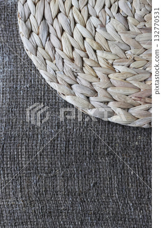 One placemat made of water hyacinth on rough linen burlap. One placemat made of water hyacinth on rough linen burlap. 132770531