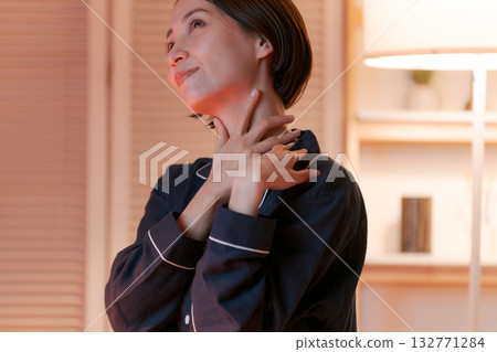 A woman doing skin care in her room at night A woman doing skin care in her room at night 132771284