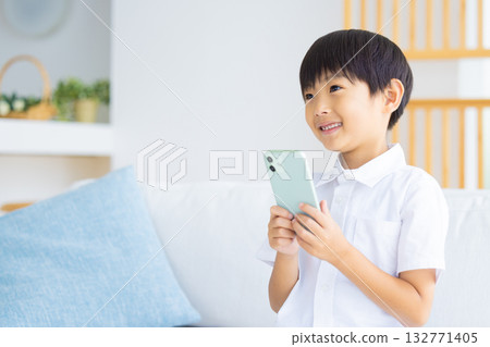 Boy looking at a smartphone Boy looking at a smartphone 132771405