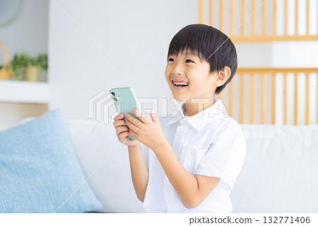 Boy looking at a smartphone 132771406