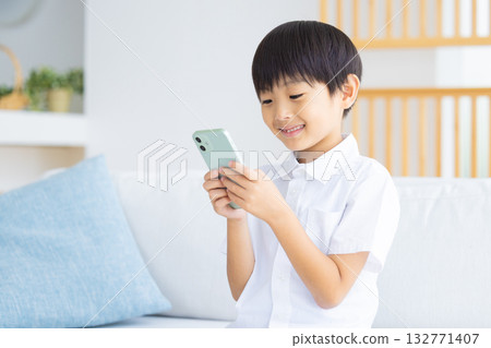 Boy looking at a smartphone 132771407