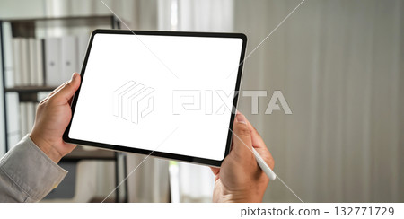 businessman holds a mockup. iPad digital tablet with blank screen Mockup replaces your design mockup in the office. 132771729