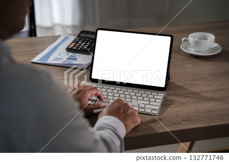 iPad Digital tablet mockup on wooden desk with keyboard, blank white screen and copy space. Hands with stylus remote work and UI design. 132771746