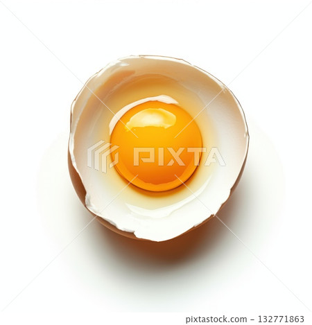 Fresh egg shell with bright yellow yolk resting on a clean surface in a bright kitchen setting 132771863