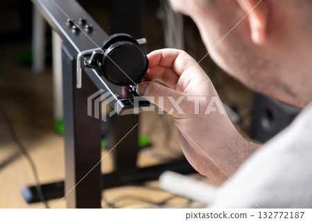 Man's hand diligently attaching a black caster wheel to a modern metal furniture frame for efficient home office desk assembly project Man's hand diligently attaching a black caster wheel to a modern metal furniture frame for efficient home office desk assembly project 132772187
