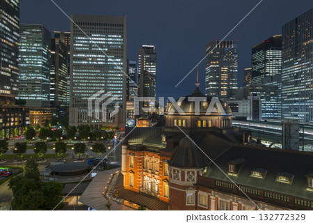 Tokyo Station illuminated by the setting sun, a shining business district at night, a businessman returning home from a night intersection Tokyo Station illuminated by the setting sun, a shining business district at night, a businessman returning home from a night intersection 132772329