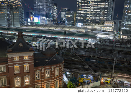 Tokyo Station illuminated by the setting sun, a shining business district at night, a businessman returning home from a night intersection Tokyo Station illuminated by the setting sun, a shining business district at night, a businessman returning home from a night intersection 132772330