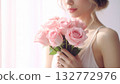 High-resolution image of a bouquet of pink roses held by a woman 132772976