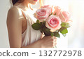 High-resolution image of a bouquet of pink roses held by a woman 132772978