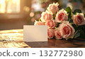 High resolution composition of a bouquet of roses and a card placed on a wooden table 132772980