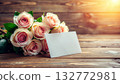 High resolution composition of a bouquet of roses and a card placed on a wooden table 132772981
