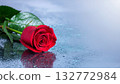 High-resolution close-up of a single red rose floating against a blue background 132772984