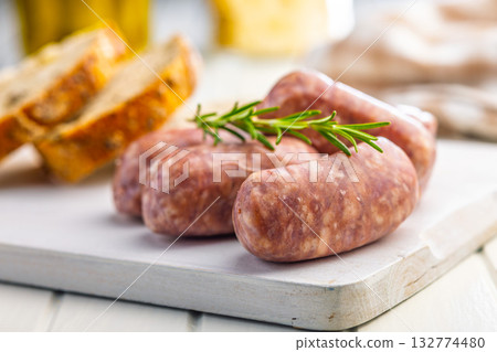 Photo of italian sausage salsiccia on cutting board on white table. 132774480