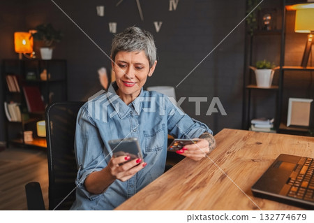 Woman making online payment using credit card and smartphone 132774679