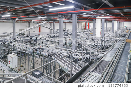 packing line in a logistics warehouse. conveyor belt in a modern production line packing line in a logistics warehouse. conveyor belt in a modern production line 132774863