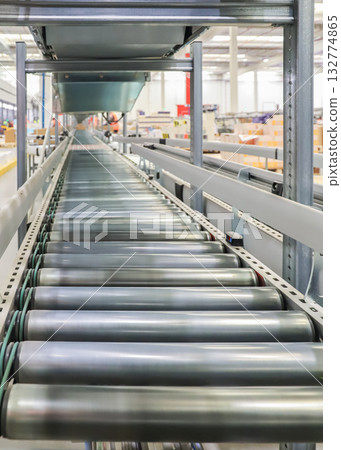 packing line in a logistics warehouse. conveyor belt in a modern production line packing line in a logistics warehouse. conveyor belt in a modern production line 132774865