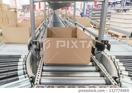 packing line in a logistics warehouse. conveyor belt in a modern production line packing line in a logistics warehouse. conveyor belt in a modern production line 132774869