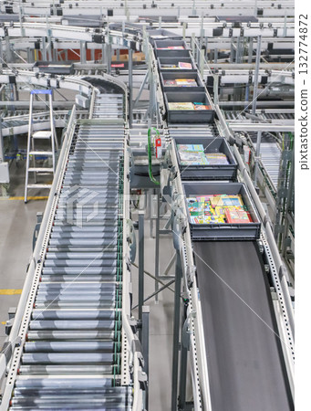 packing line in a logistics warehouse. conveyor belt in a modern production line 132774872