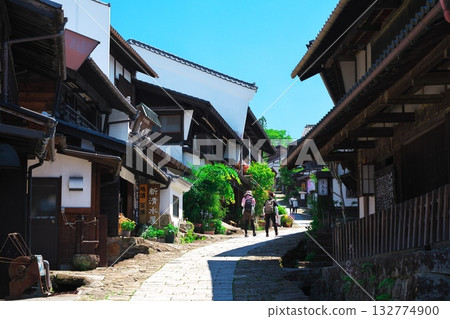 Tourists strolling around Magome, a post town in early summer Tourists strolling around Magome, a post town in early summer 132774900