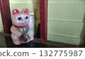 An old lucky cat brings good luck to its owner, placed on the table next to the wall 132775987