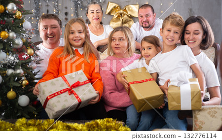 Family with children holding gifts in christmas interior 132776114