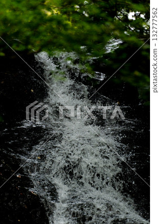 Water splashing on the rocks of a waterfall Water splashing on the rocks of a waterfall 132777562