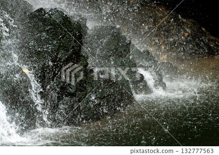 Water splashing on the rocks of a waterfall Water splashing on the rocks of a waterfall 132777563