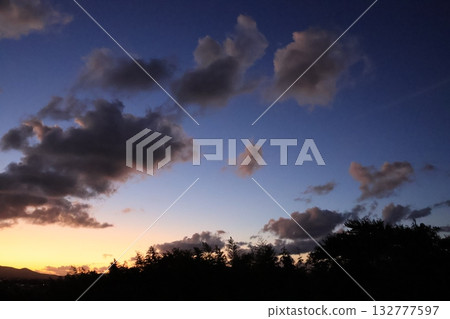 Autumn sunset seen through the clouds Autumn sunset seen through the clouds 132777597