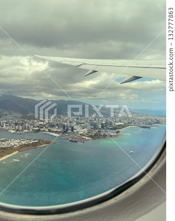 View of the cityscape and coastline of Honolulu, Hawaii from an airplane window View of the cityscape and coastline of Honolulu, Hawaii from an airplane window 132777863