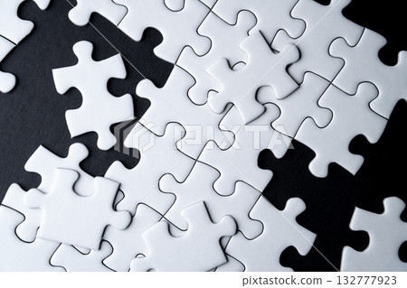 White jigsaw puzzle with missing piece and black background White jigsaw puzzle with missing piece and black background 132777923