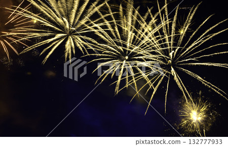 Golden fireworks burst in night sky Golden fireworks burst in night sky 132777933