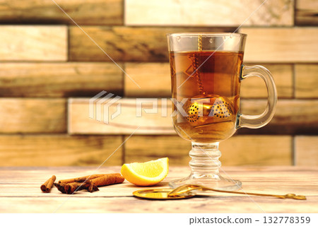 Cup of Cinnamon Lemon Tea on Wooden Table 132778359