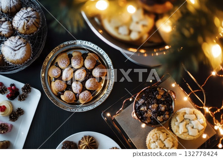 Festive holiday desserts with cookies and pastries in warm ambient lighting 132778424