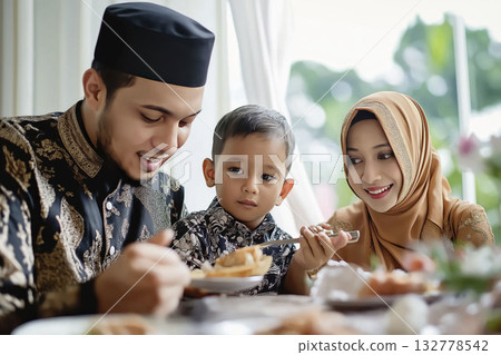Happy family celebrating eid with traditional meal and joyful bonding 132778542